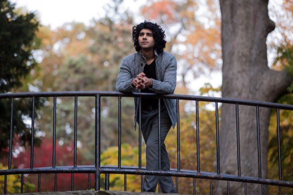 Young man on a bridge in autumn