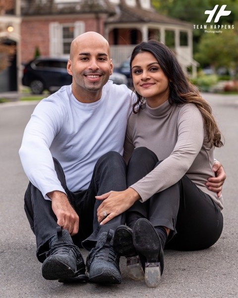 Couple sitting together on the street