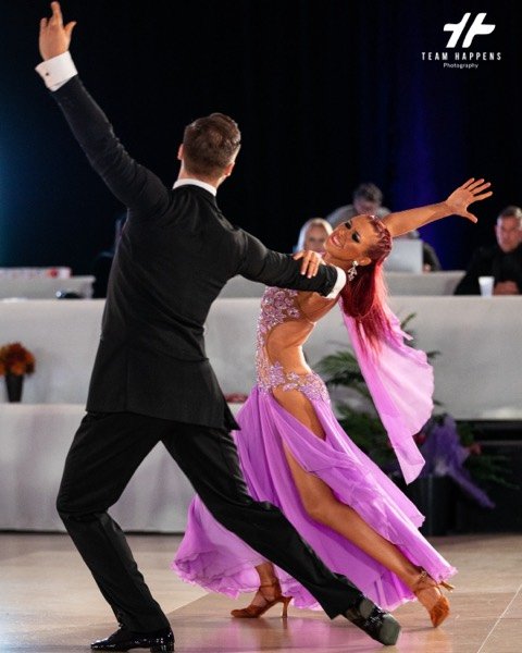 Dancer in a purple gown mid spin