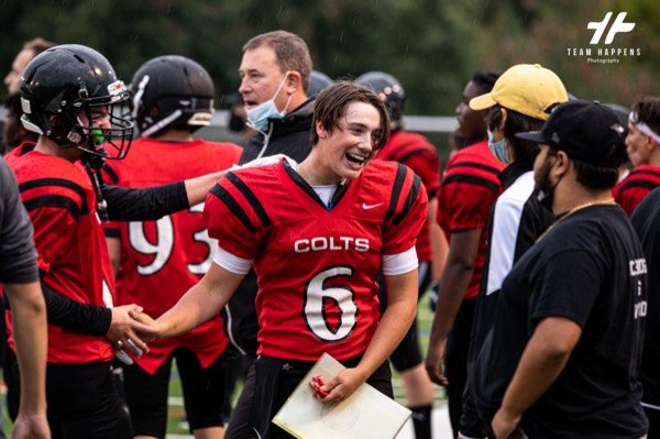 Football team celebrating on the sideline