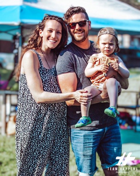 Family of three by the water