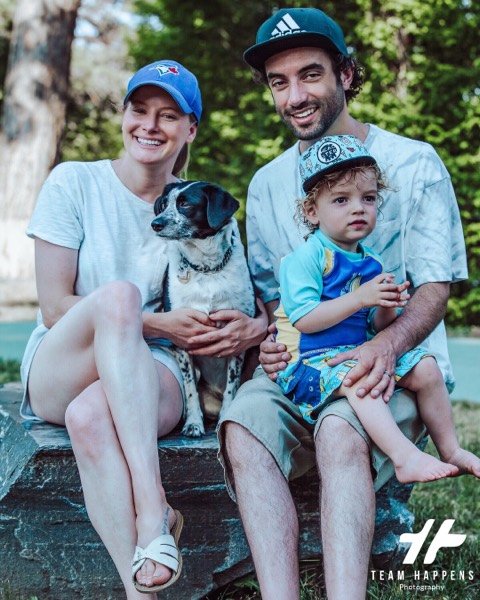 Family with their dog on a bench