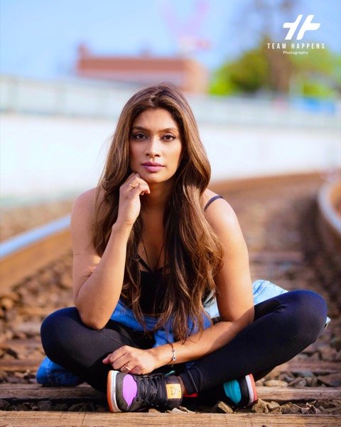 Woman sitting on railway tracks