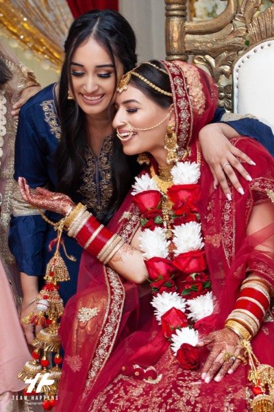 Bride laughing with her sister on the wedding day