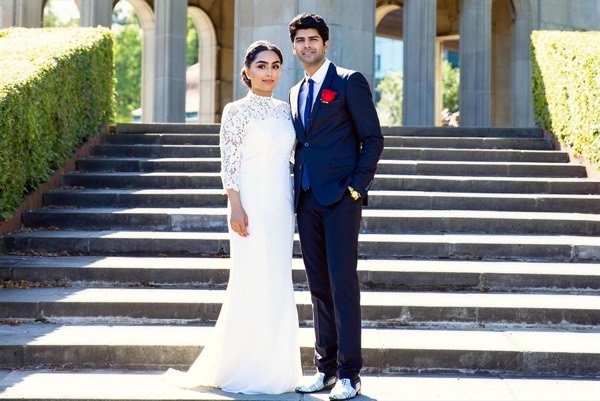 Bride and groom on the steps of a stone terrace